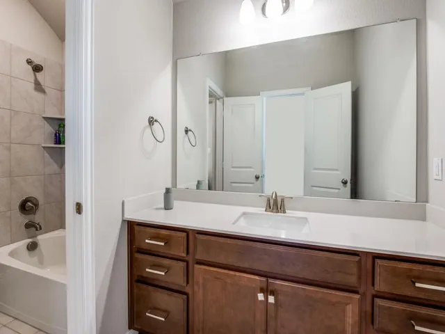 a view of a kitchen with white cabinets