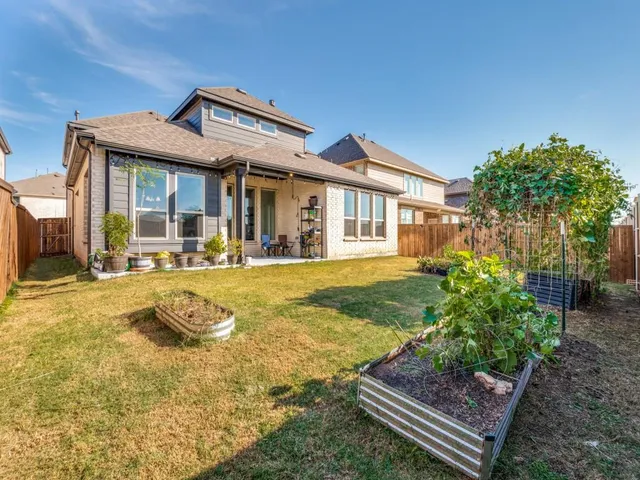 a view of a patio with table and chairs and potted plants