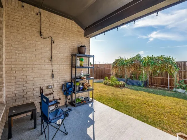 a backyard of house with swing and plants