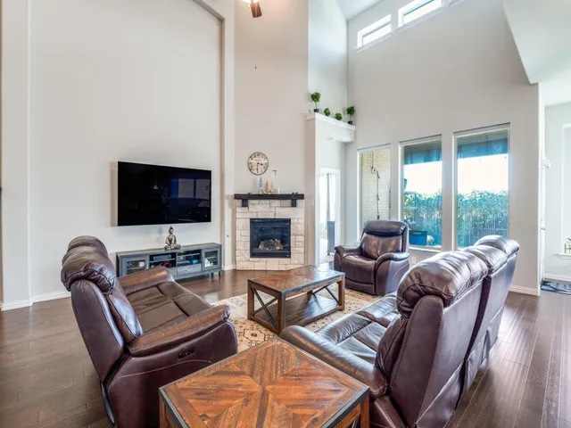 a living room with furniture fireplace and flat screen tv