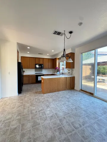 a view of kitchen with refrigerator and window