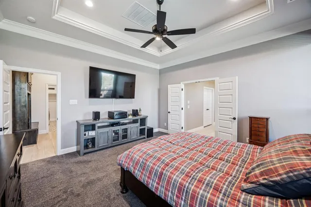 a bedroom with a bed and dresser with view