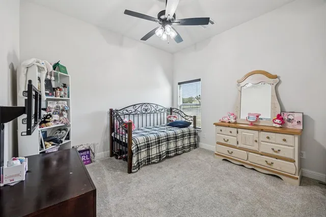a living room with furniture a rug and kitchen view