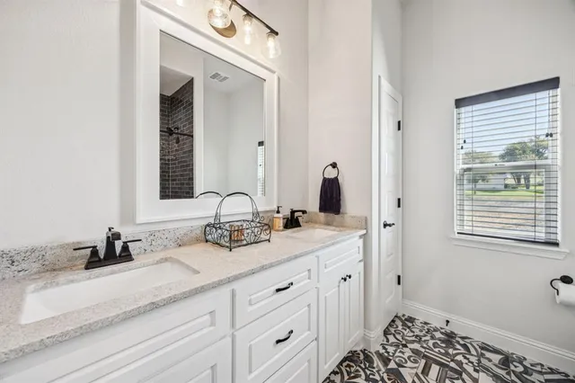 a bedroom with bed and a chandelier