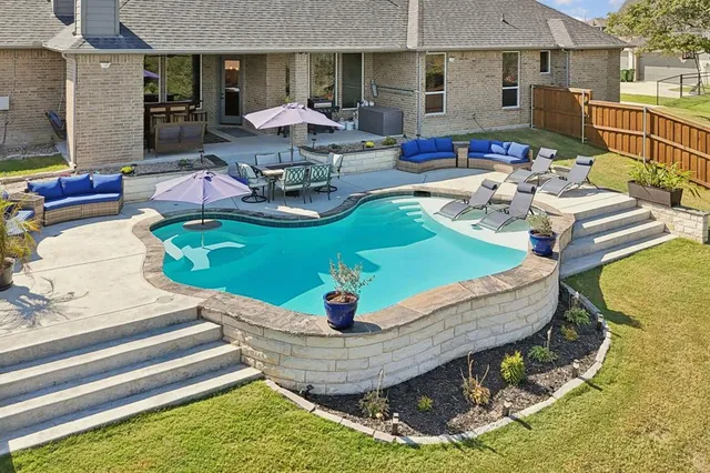 a living room with fireplace furniture and a large window