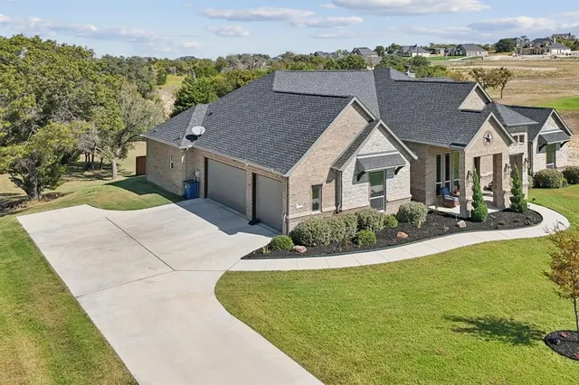 a aerial view of a house with a yard table and chairs