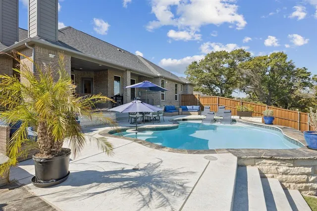 a view of a patio with a dining table and chairs with wooden floor
