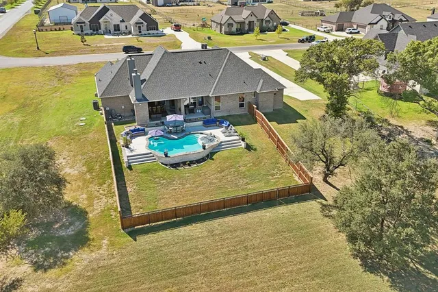 a view of a backyard with plants and patio
