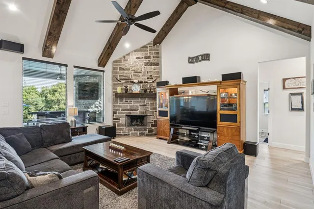 a living room with furniture a flat screen tv and a fireplace