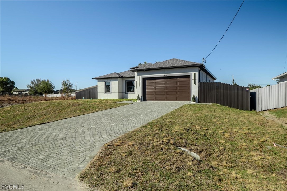3206 14th Street Southwest Lehigh Acres, FL 33976 - Photo 1 of 38 a front view of a house with a yard