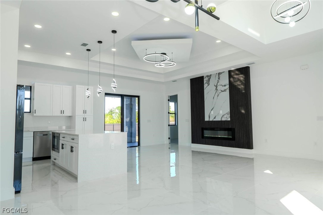 3206 14th Street Southwest Lehigh Acres, FL 33976 - Photo 11 of 38 a view of a hallway with wooden floor and a living room