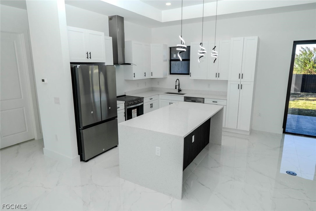 3206 14th Street Southwest Lehigh Acres, FL 33976 - Photo 12 of 38 a kitchen with a white stove top oven and refrigerator