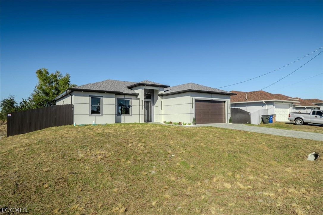 3206 14th Street Southwest Lehigh Acres, FL 33976 - Photo 2 of 38 front view of a house with a yard