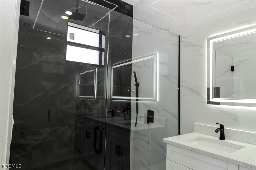 3206 14th Street Southwest Lehigh Acres, FL 33976 - Photo 23 of 38 a bathroom with a sink and mirror