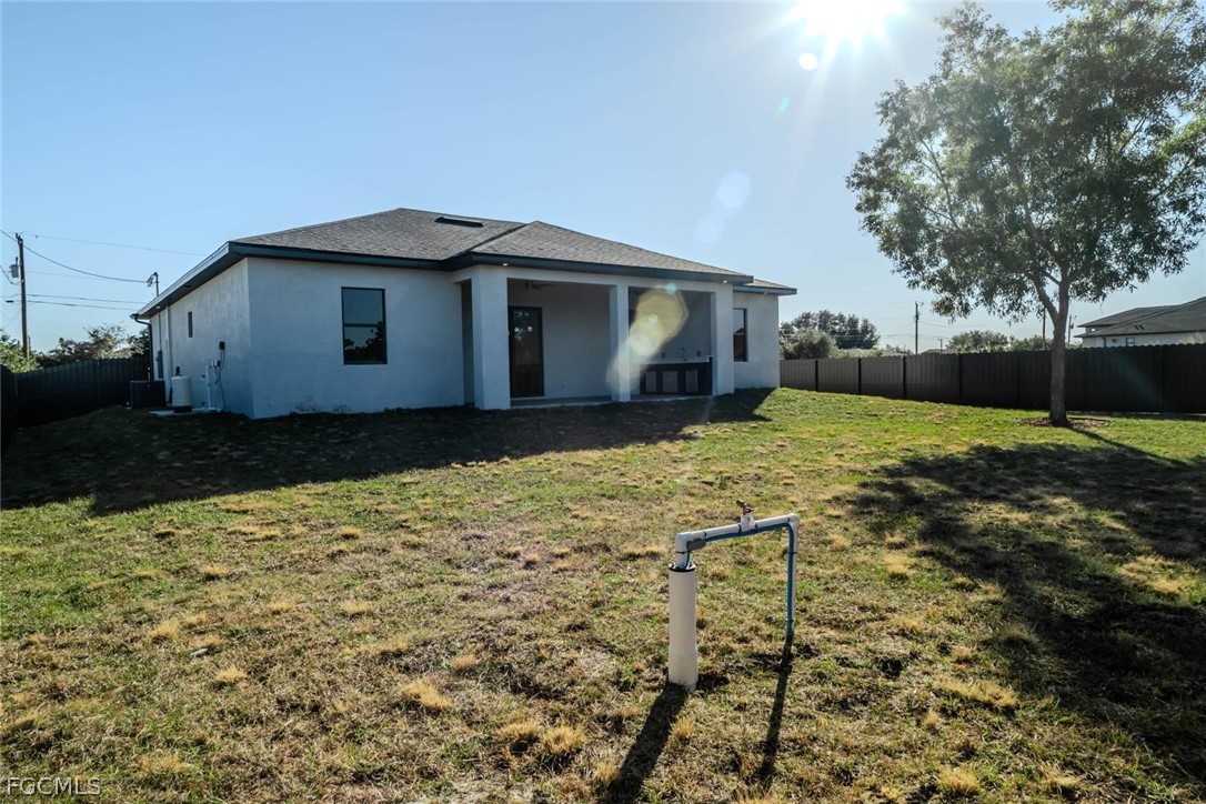 3206 14th Street Southwest Lehigh Acres, FL 33976 - Photo 27 of 38 a house with trees in the background