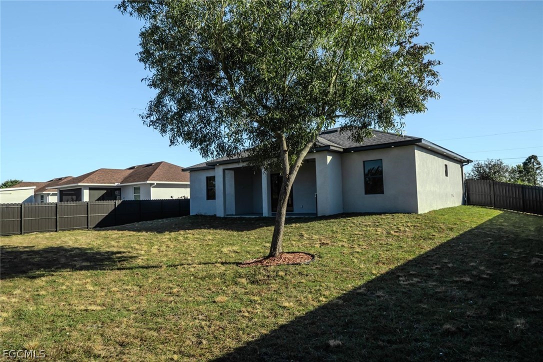 3206 14th Street Southwest Lehigh Acres, FL 33976 - Photo 28 of 38 a house view with a garden space