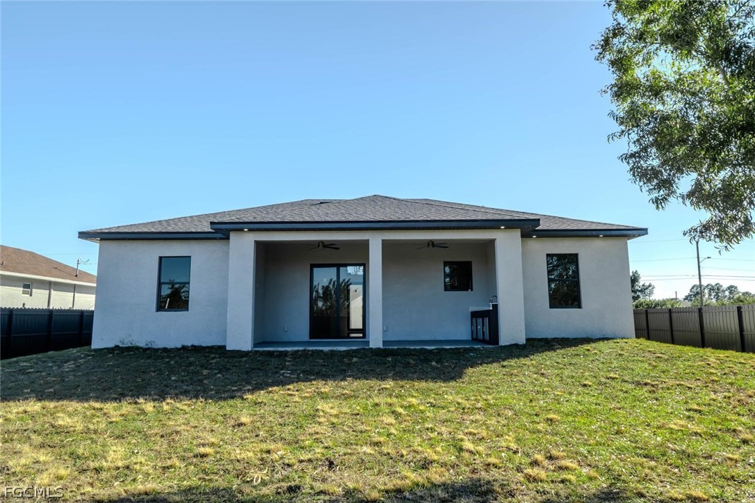 3206 14th Street Southwest Lehigh Acres, FL 33976 - Photo 29 of 38 a house with a yard