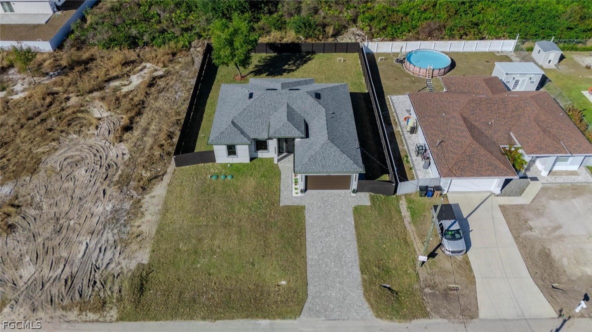 3206 14th Street Southwest Lehigh Acres, FL 33976 - Photo 30 of 38 an aerial view of a house with outdoor space and a lake view