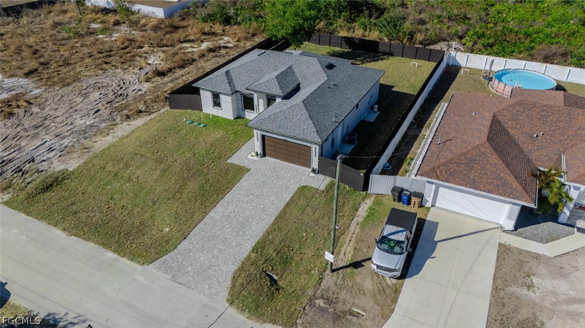 3206 14th Street Southwest Lehigh Acres, FL 33976 - Photo 31 of 38 an aerial view of a house with a garden and plants