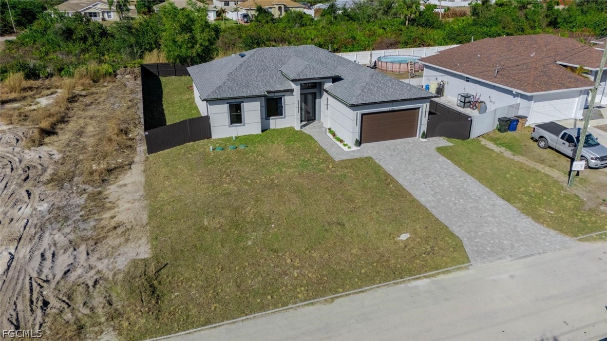 3206 14th Street Southwest Lehigh Acres, FL 33976 - Photo 32 of 38 an aerial view of a house with a garden