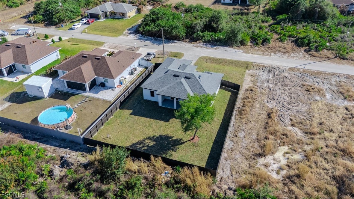 3206 14th Street Southwest Lehigh Acres, FL 33976 - Photo 34 of 38 an aerial view of a house with a swimming pool