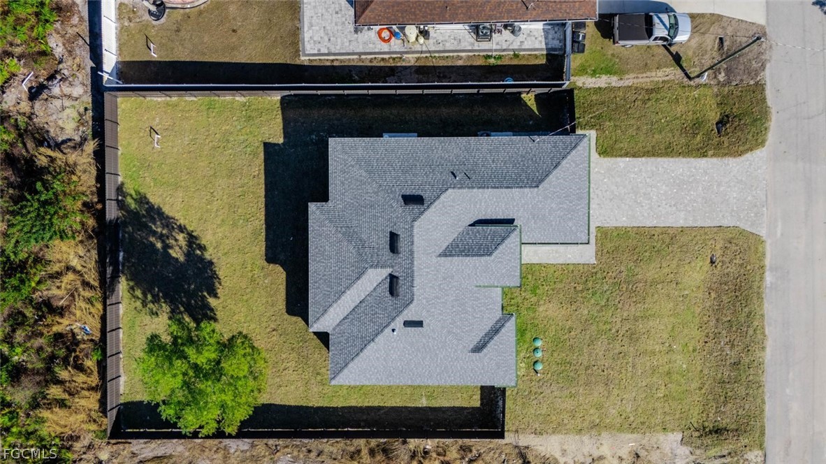 3206 14th Street Southwest Lehigh Acres, FL 33976 - Photo 35 of 38 an aerial view of a house with a yard