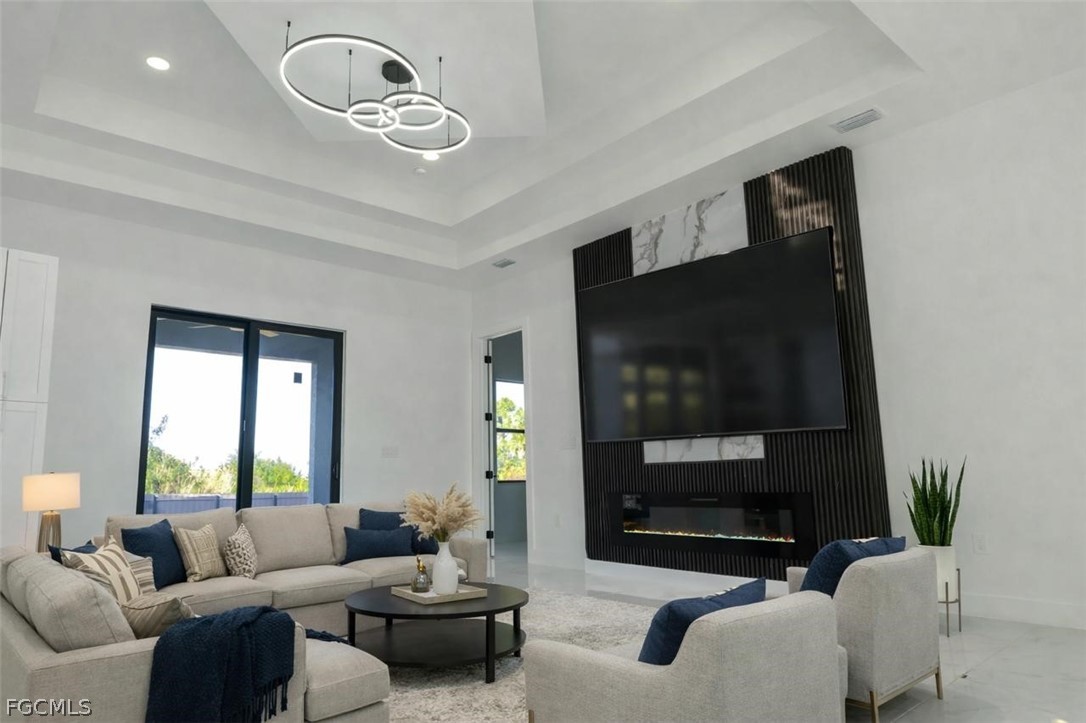 3206 14th Street Southwest Lehigh Acres, FL 33976 - Photo 37 of 38 a living room with furniture and a flat screen tv