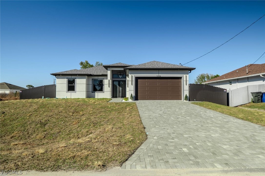 3206 14th Street Southwest Lehigh Acres, FL 33976 - Photo 38 of 38 front view of a house with a yard