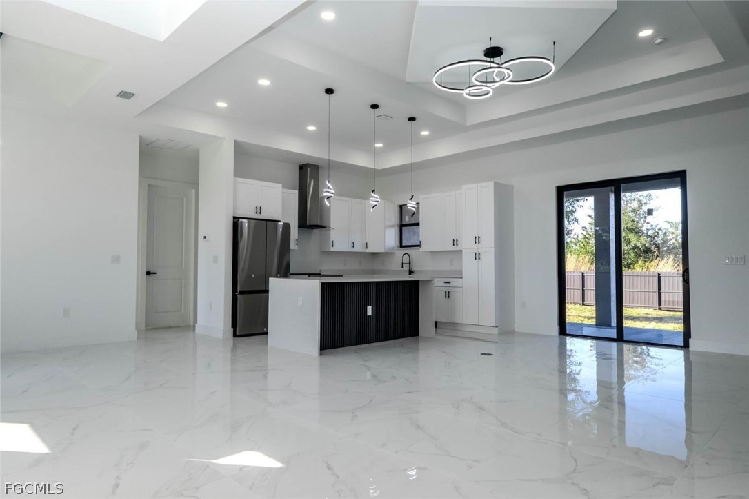 3206 14th Street Southwest Lehigh Acres, FL 33976 - Photo 7 of 38 a large kitchen with stainless steel appliances granite countertop a refrigerator and a sink