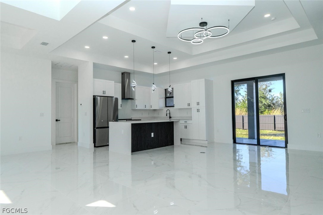 3206 14th Street Southwest Lehigh Acres, FL 33976 - Photo 8 of 38 a large room with a refrigerator and a sink