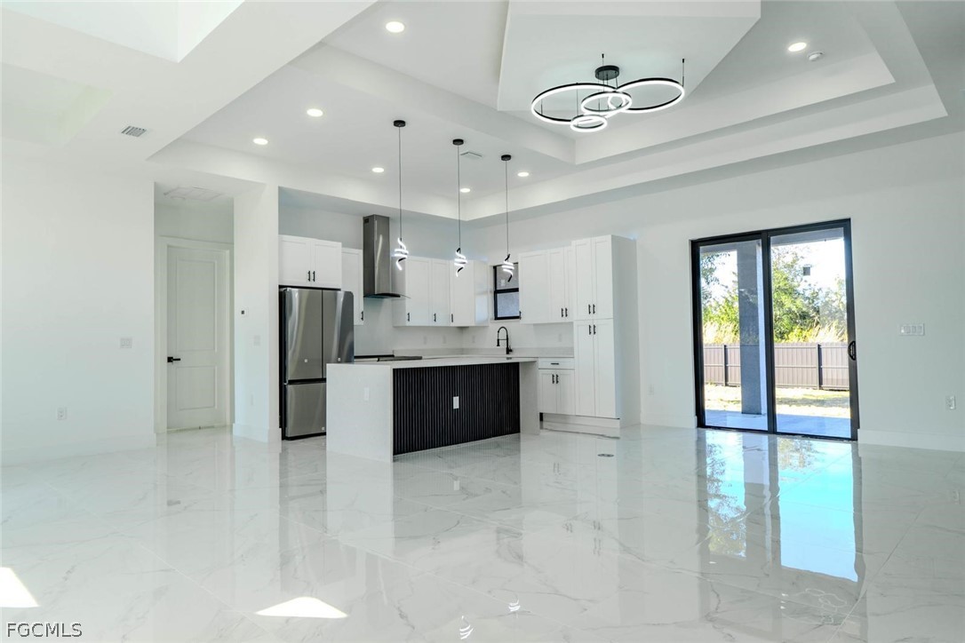 3206 14th Street Southwest Lehigh Acres, FL 33976 - Photo 9 of 38 a large kitchen with stainless steel appliances a refrigerator and a sink