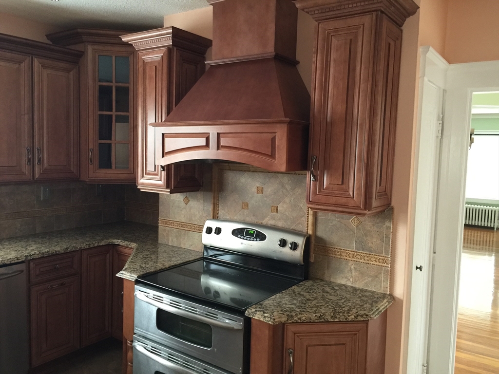 128 Institute Road, Unit 2 Worcester, MA 01602 - Photo 2 of 9 a kitchen with a stove and a microwave