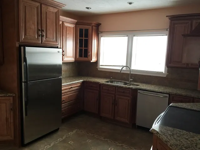 a kitchen with a refrigerator and a sink