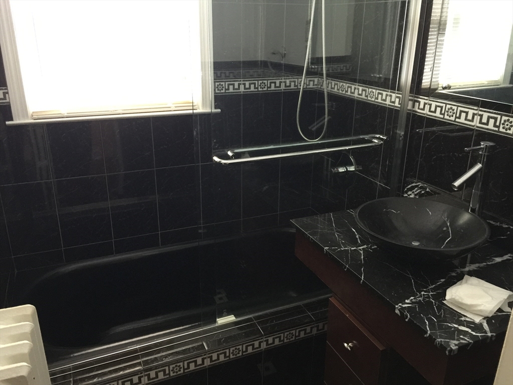 128 Institute Road, Unit 2 Worcester, MA 01602 - Photo 7 of 9 a bathroom with a sink a toilet and a mirror