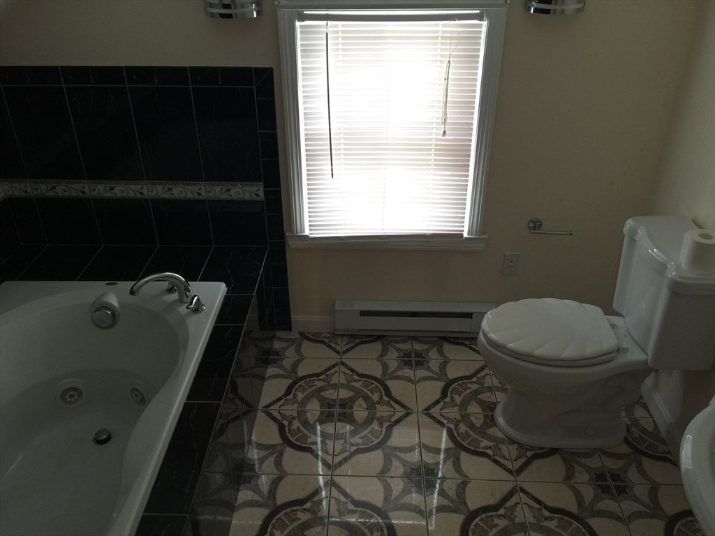 128 Institute Road, Unit 2 Worcester, MA 01602 - Photo 9 of 9 a bathroom with a sink toilet and window