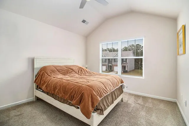 a bedroom with a bed and window