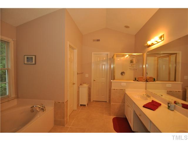 9008 Breeland Way Raleigh, NC 27613 - Photo 13 of 18 Spacious bath with cathedral ceiling, walk in closet, dual vanity, garden tub and separate shower