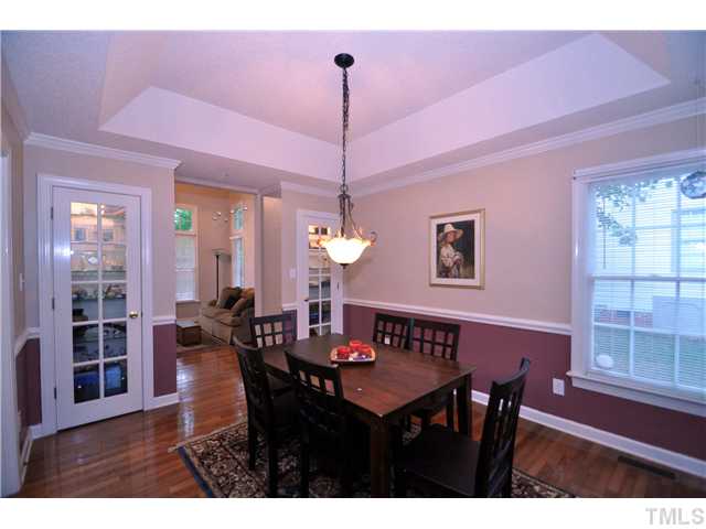 9008 Breeland Way Raleigh, NC 27613 - Photo 5 of 18 Formal dining room has trey cieling, hardwood floor and 2 built-in china cabinets