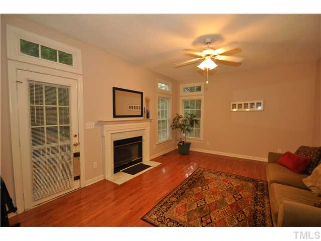 9008 Breeland Way Raleigh, NC 27613 - Photo 6 of 18 Family room adjacent to kitchen with hardwood floors, gas log fireplace and access to deck