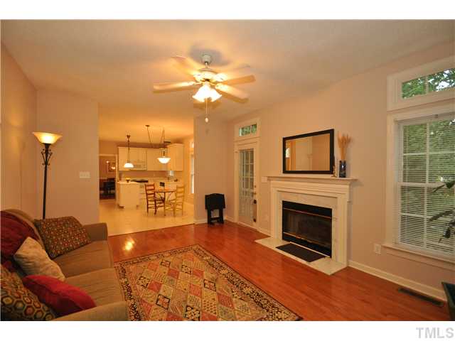 9008 Breeland Way Raleigh, NC 27613 - Photo 7 of 18 Family room adjacent to kitchen with hardwood floors, gas log fireplace and access to deck