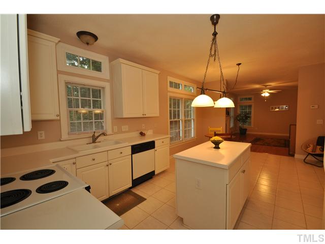 9008 Breeland Way Raleigh, NC 27613 - Photo 9 of 18 Open kitchen with tile floor, 42" cabinets and center island