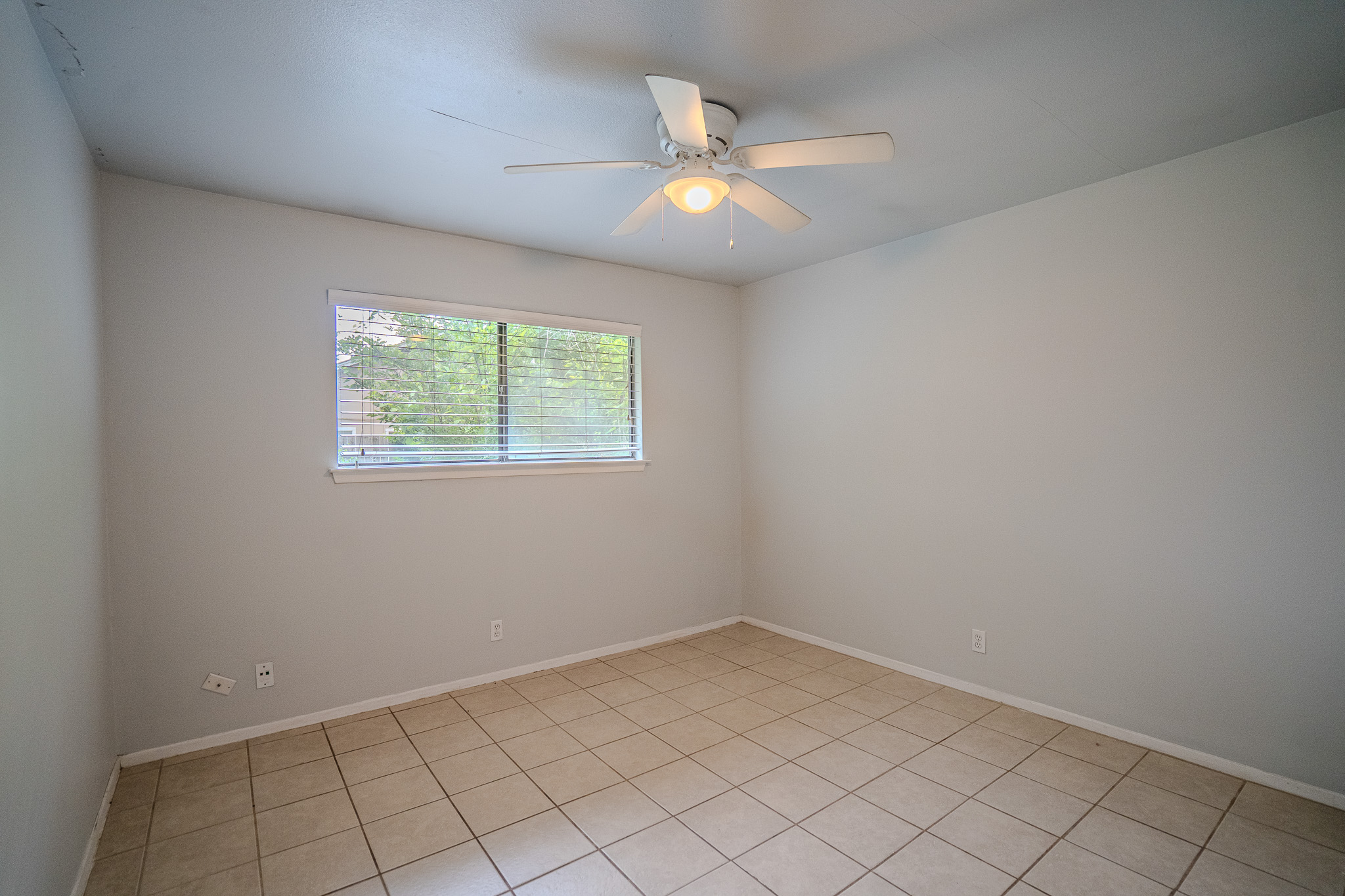 12403 Tree Line Drive, Unit B Austin, TX 78729 - Photo 12 of 16 an empty room with windows