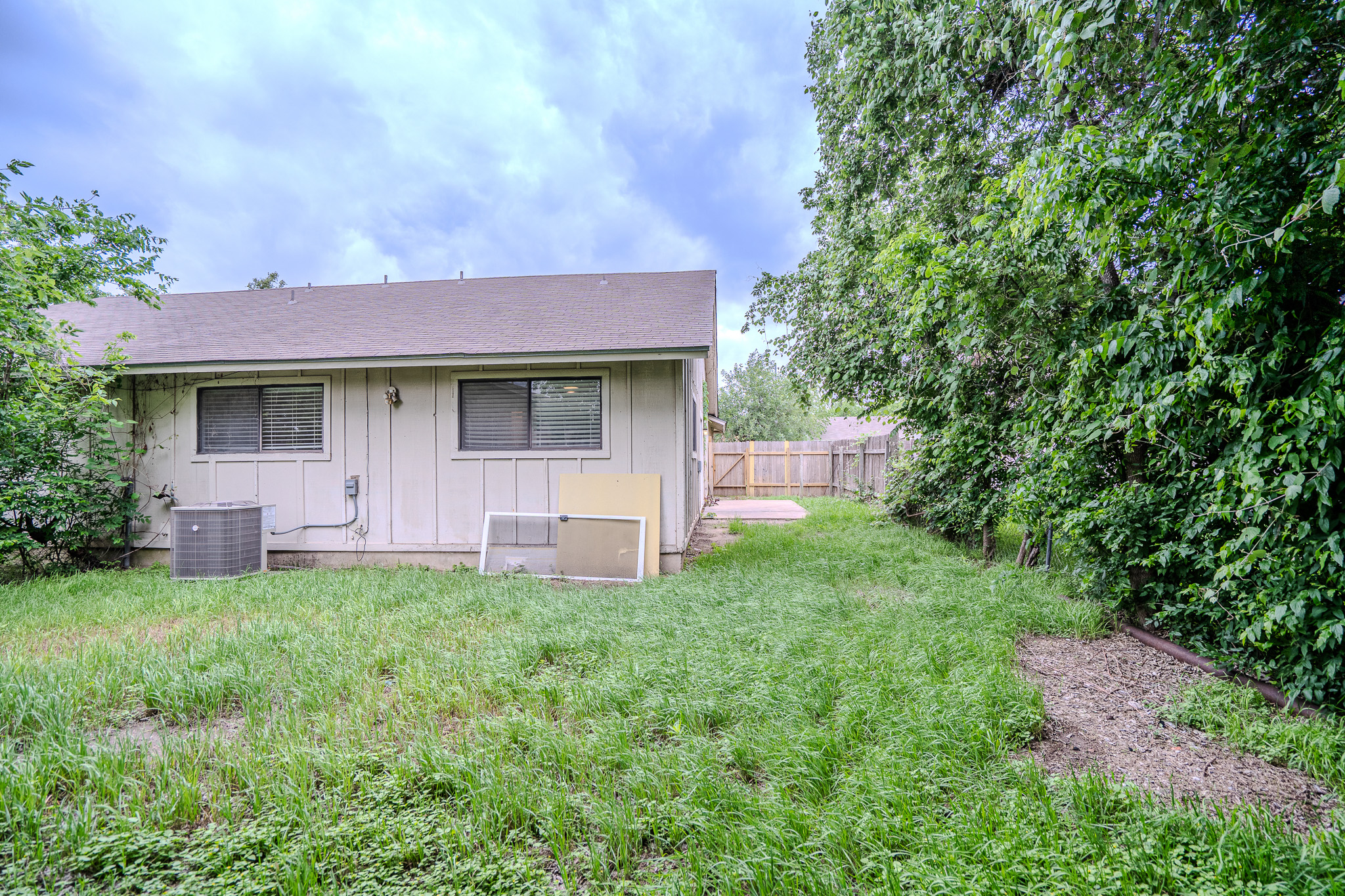 12403 Tree Line Drive, Unit B Austin, TX 78729 - Photo 14 of 16 a house view with a garden space