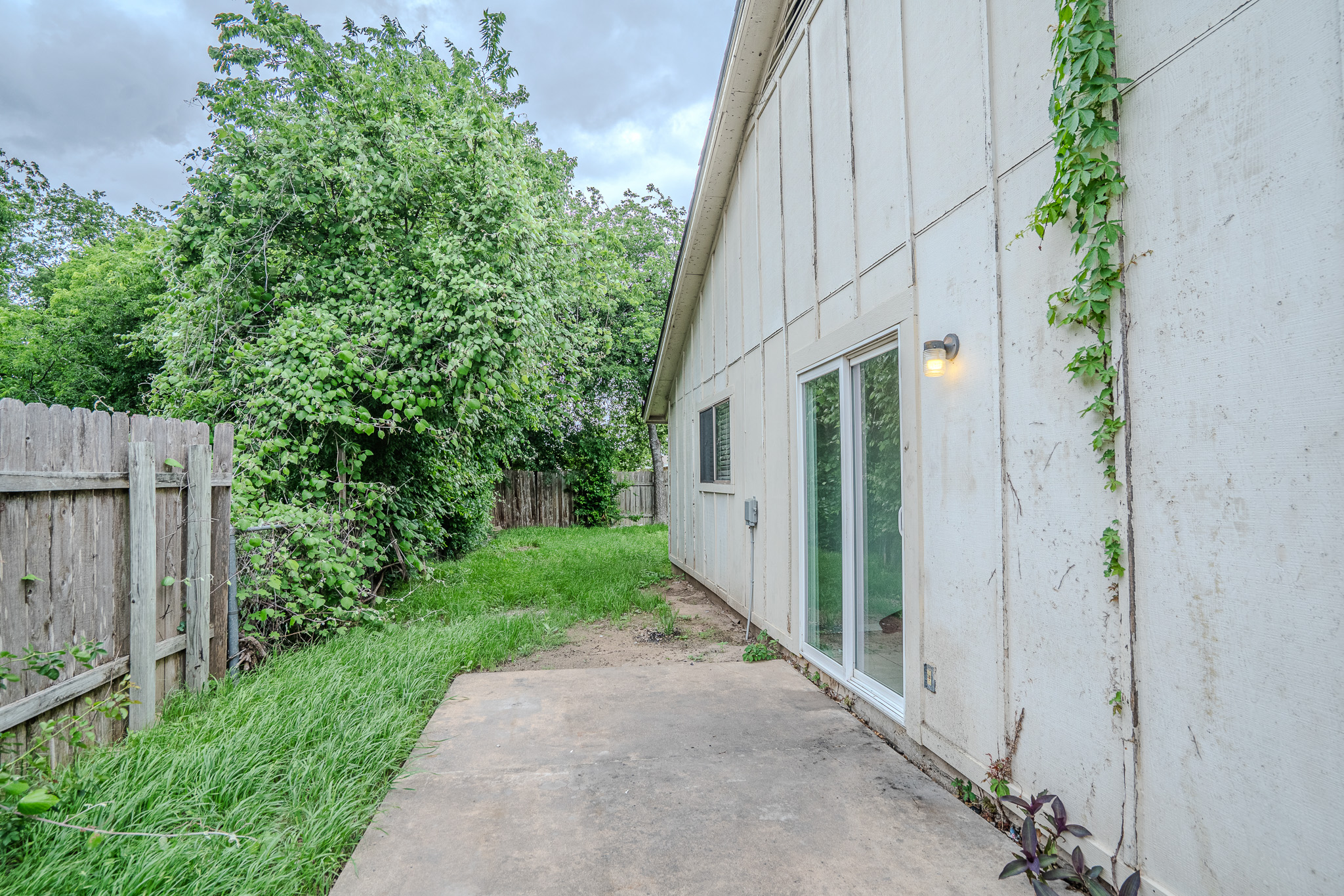 12403 Tree Line Drive, Unit B Austin, TX 78729 - Photo 16 of 16 a view of a back yard of the house
