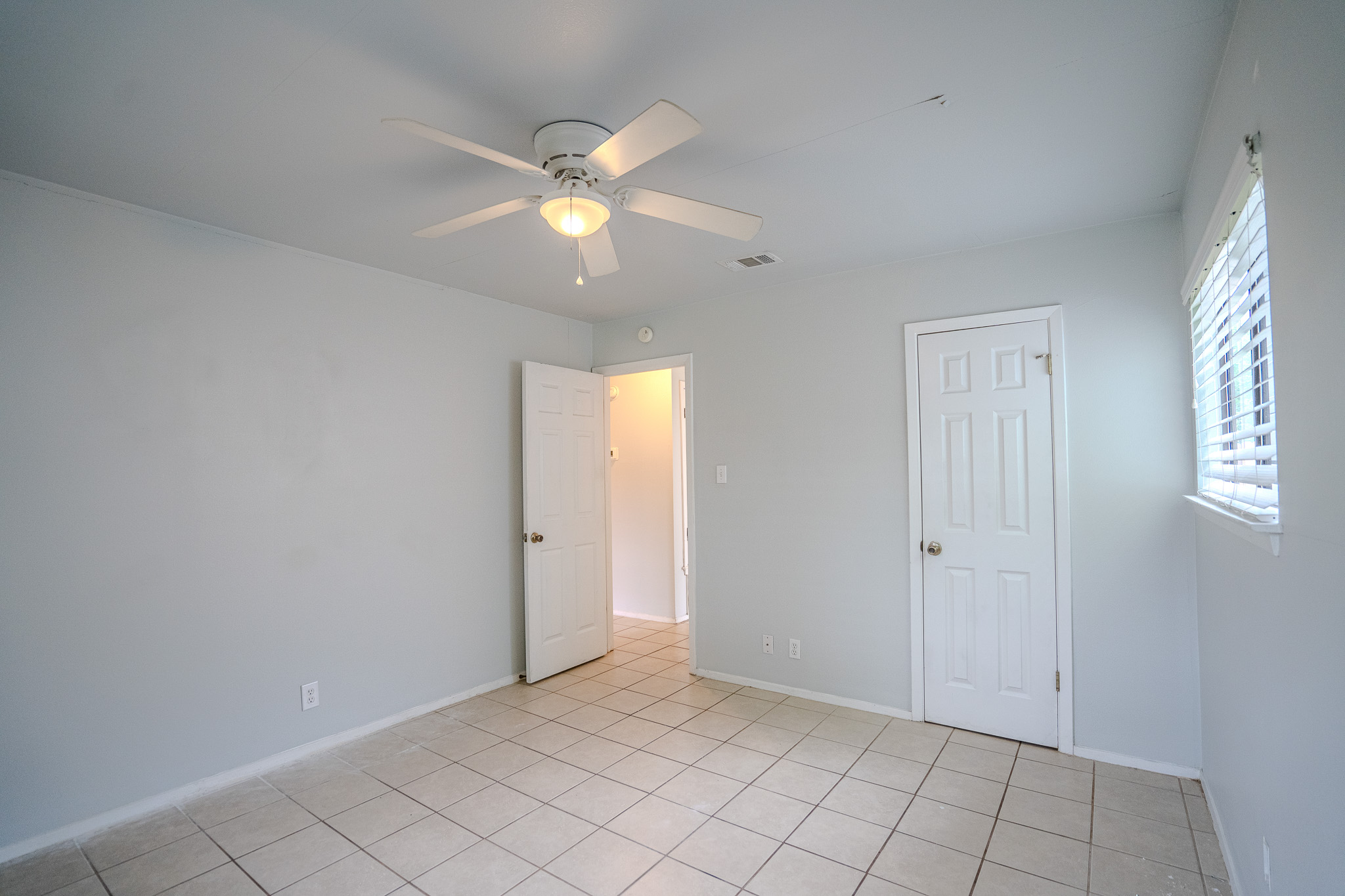 12403 Tree Line Drive, Unit B Austin, TX 78729 - Photo 10 of 16 a view of an empty room and window
