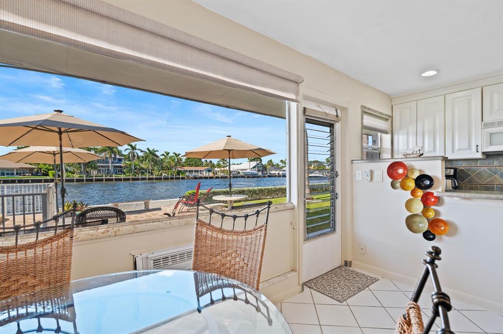 701 South Riverside Drive, Unit 107 Pompano Beach, FL 33062 - Photo 11 of 27 a living room with furniture and a floor to ceiling window