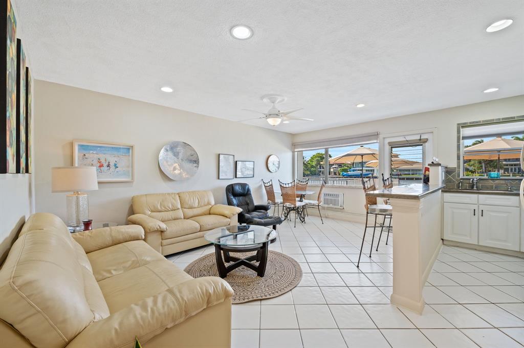 701 South Riverside Drive, Unit 107 Pompano Beach, FL 33062 - Photo 13 of 27 a living room with furniture and a table