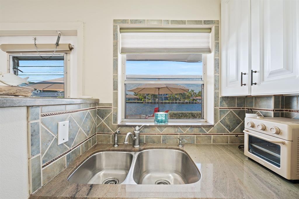 701 South Riverside Drive, Unit 107 Pompano Beach, FL 33062 - Photo 15 of 27 a kitchen with a sink cabinets and a window