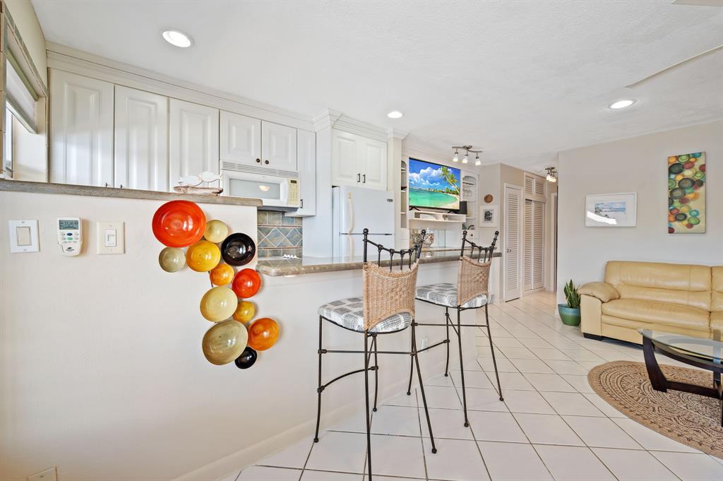 701 South Riverside Drive, Unit 107 Pompano Beach, FL 33062 - Photo 22 of 27 a living room with furniture and a table