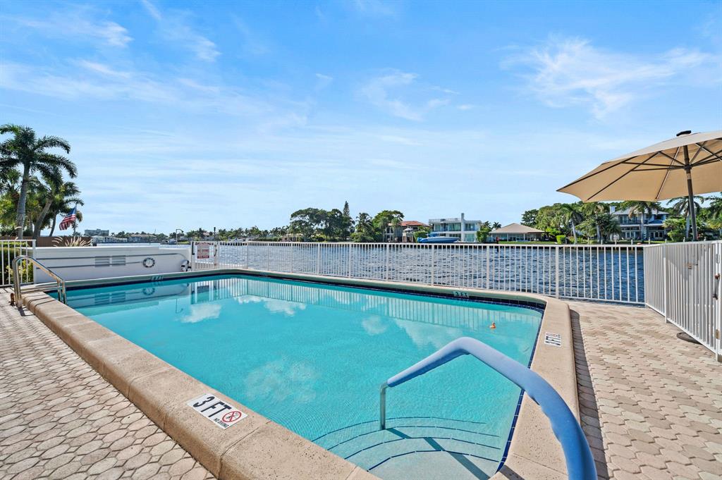 701 South Riverside Drive, Unit 107 Pompano Beach, FL 33062 - Photo 26 of 27 a view of a swimming pool with a lounge chair